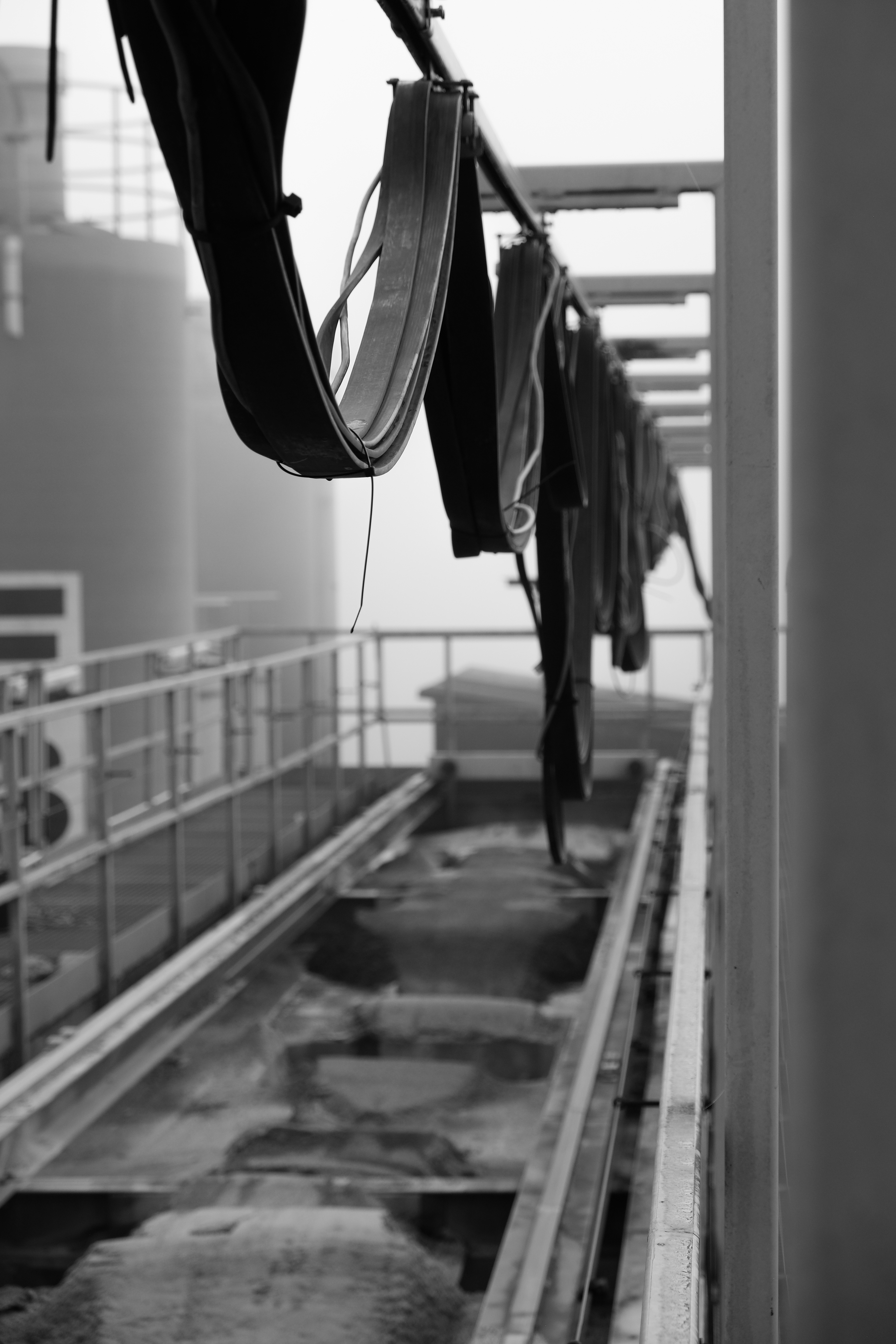 Workers among factory pipes and structures