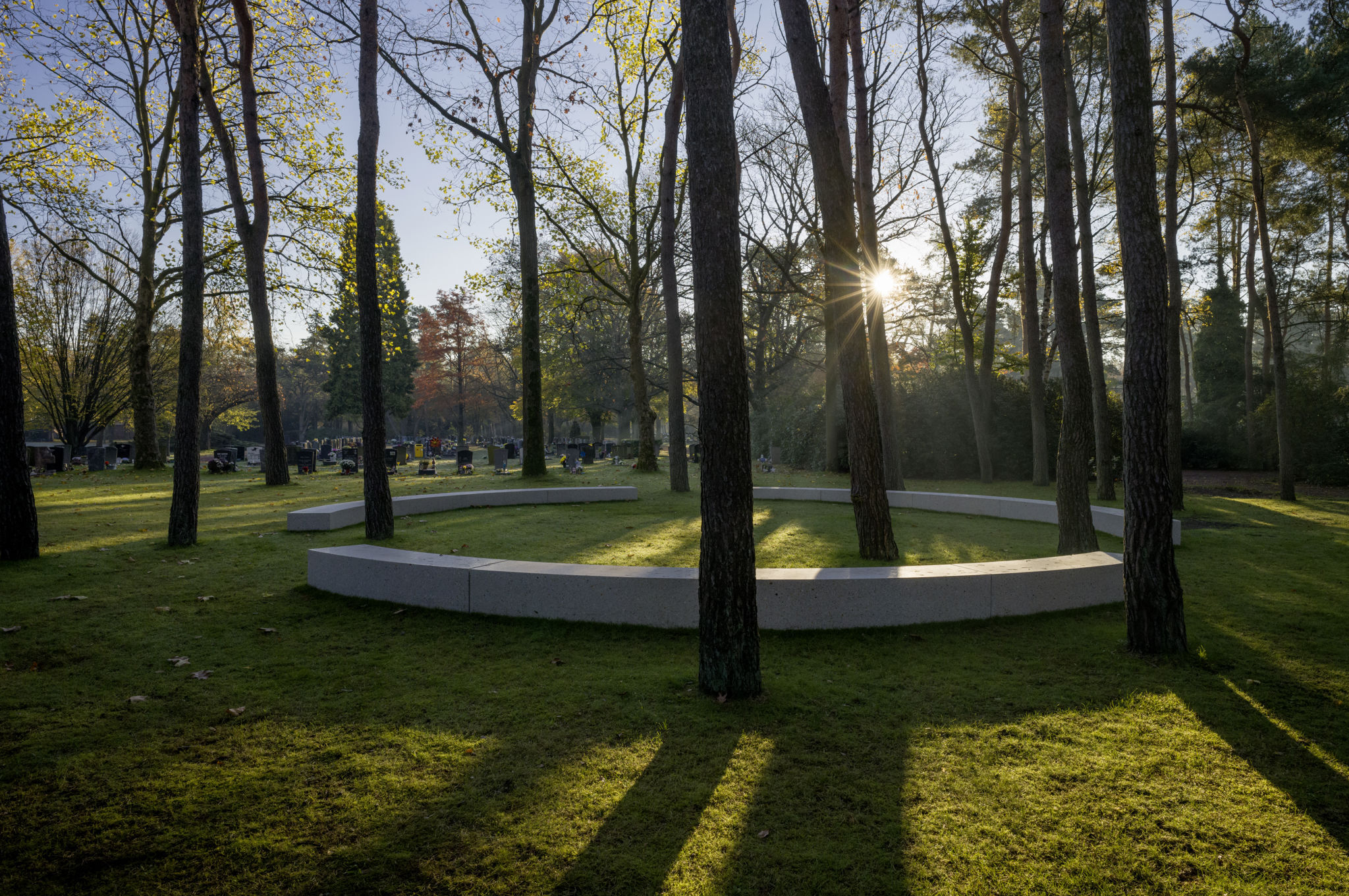 Curved concrete seating elements of the Onument memorial landscape
